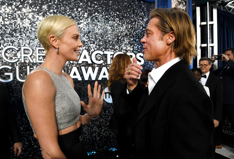 Charlize Theron and Brad Pitt talking in front of our Shimmerwall display at the SAG awards 2020.