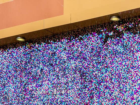 A large sequin backdrop display installed on a building.