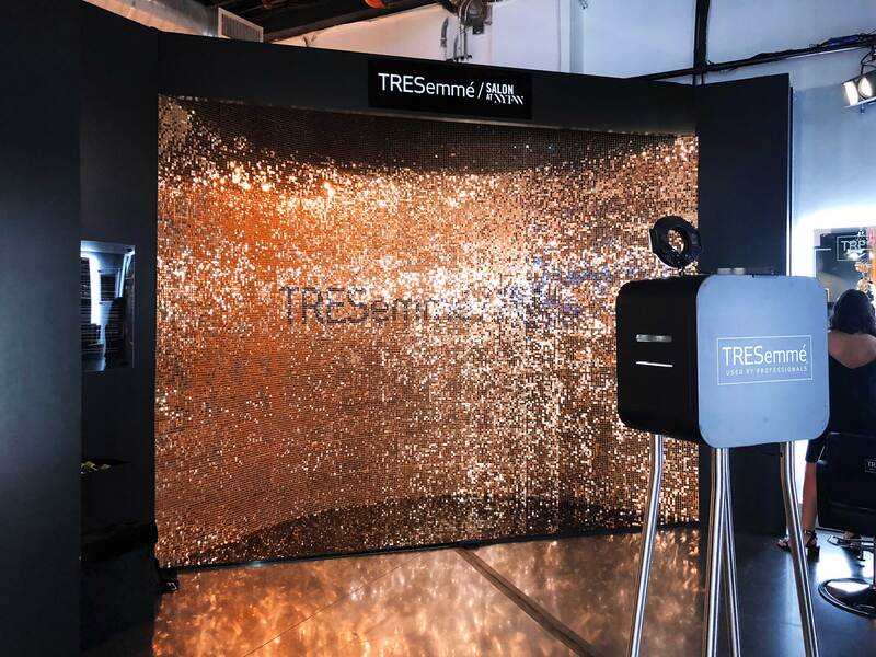 A rose gold sequin display for a hair company.