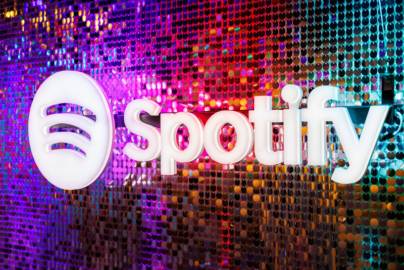 The Spotify logo mounted on top of the silver sequin backdrop.